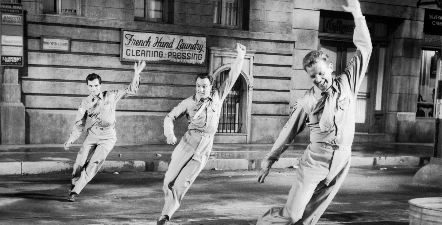 A black and white still from the set of the 1995 musical film It’s Always Fair Weather