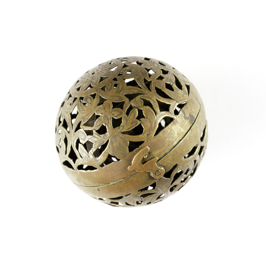 Intricately carved gold metal ball