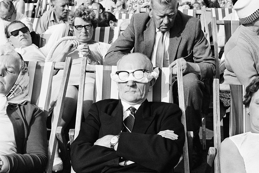 Man asleep on a deckchair on Blackpool beach