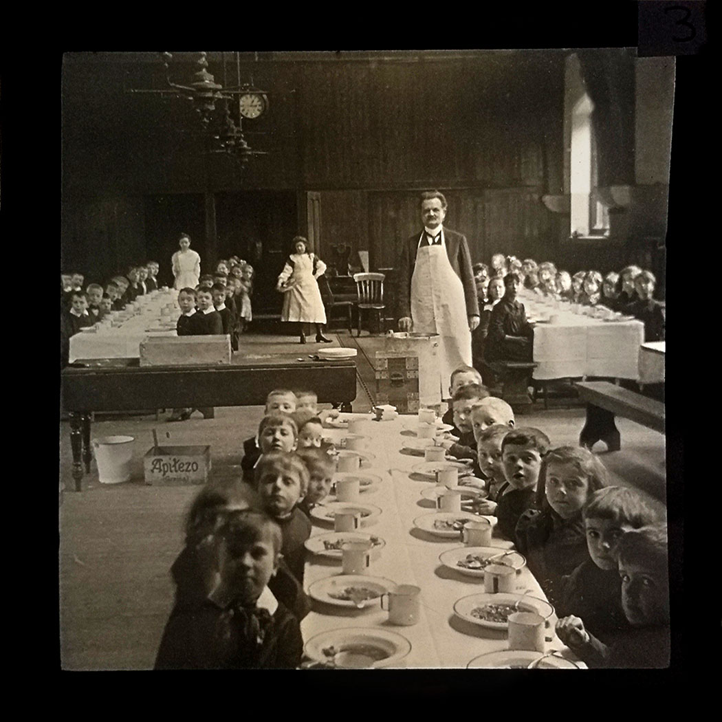 Dinner is served to the children by the Headmaster