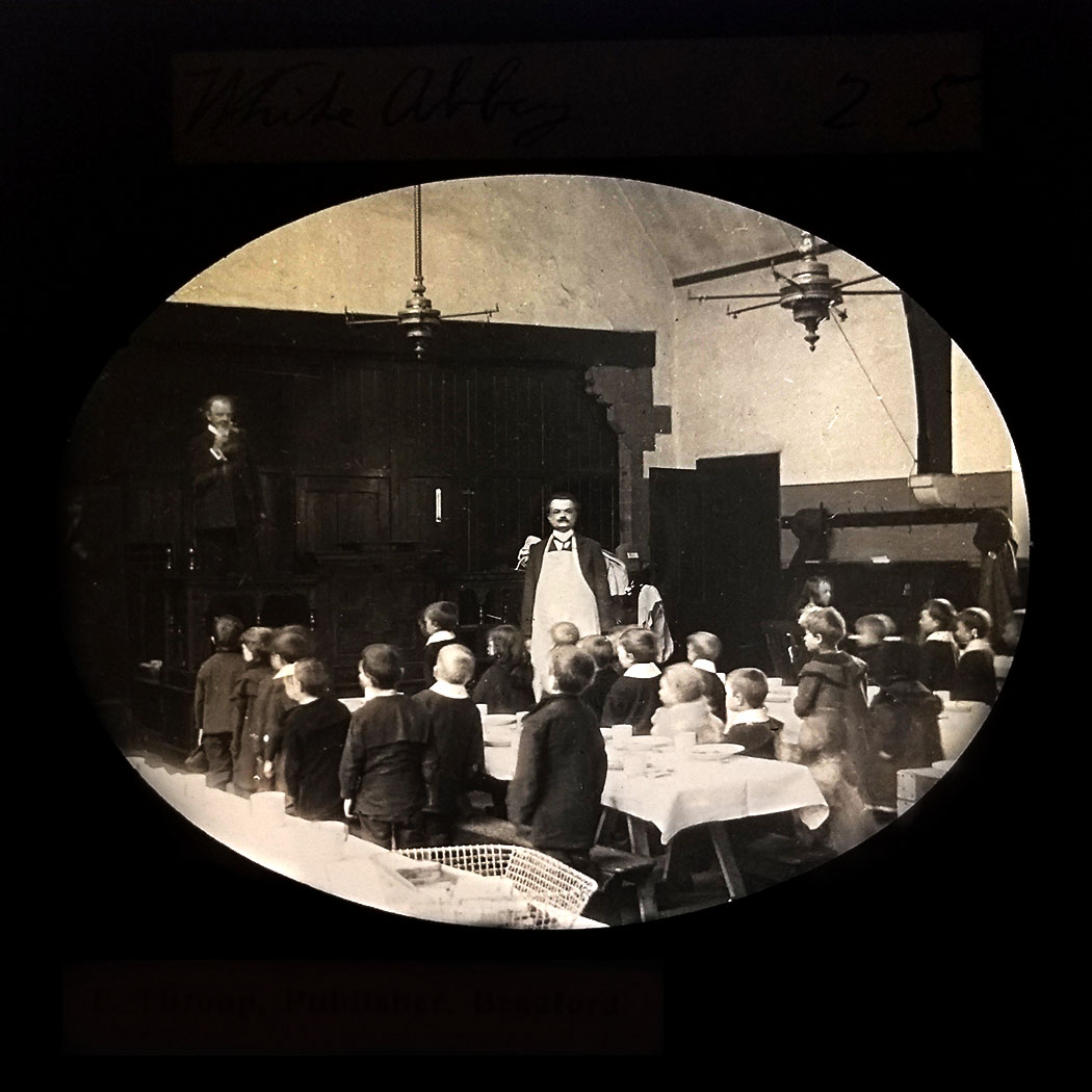 Schoolchildren listen to a speech by their headmaster