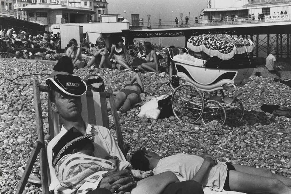 Man asleep on a deckchair on Eastbourne beach