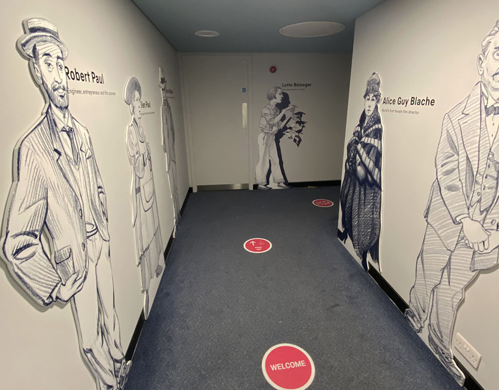 Corridor to Cubby Broccoli cinema with cut-out figures on display