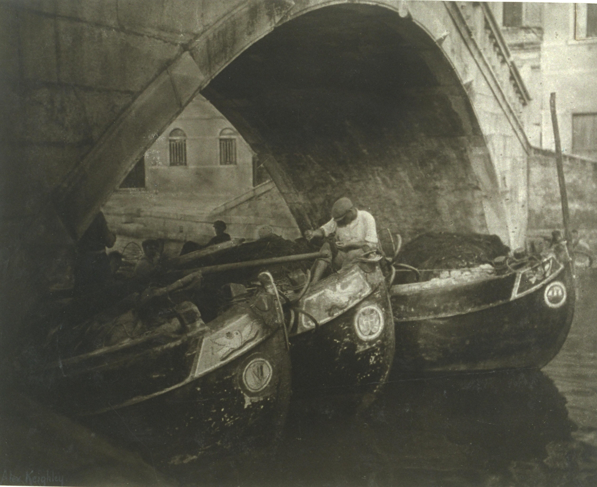 Three boats beneath a bridge
