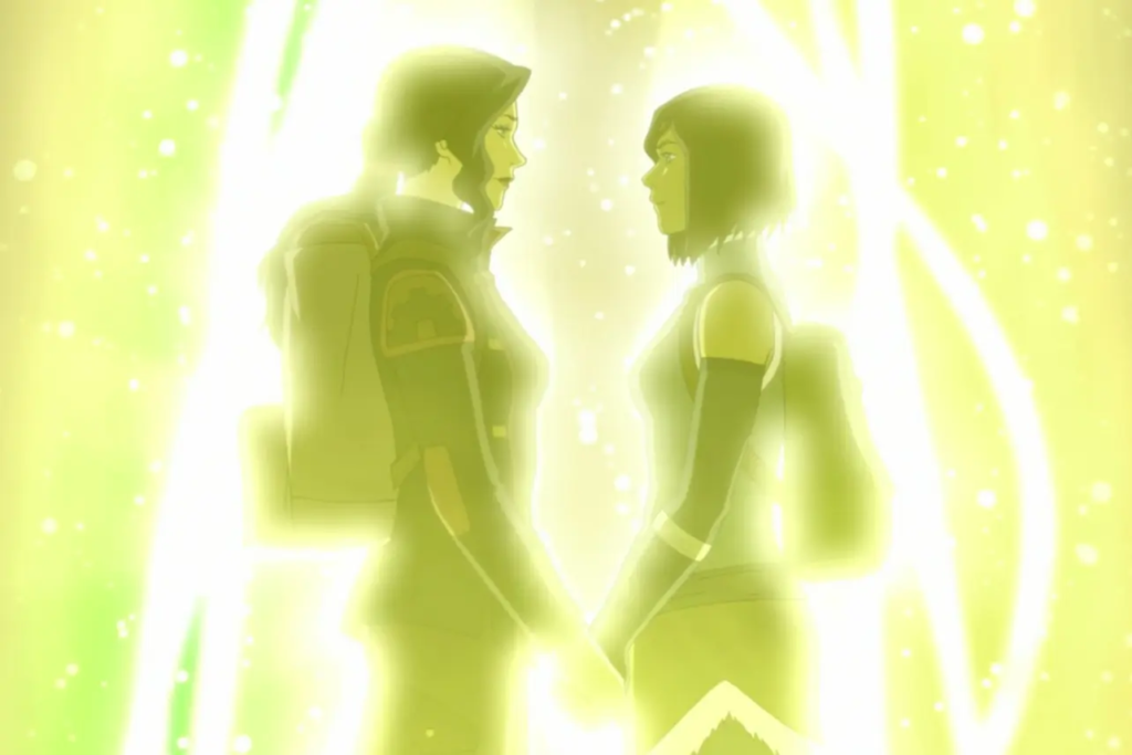 Two women stand holding hands amid a swirl of golden light