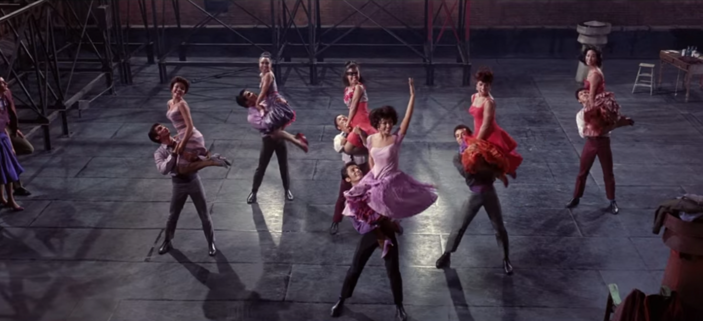 Six pairs of dancers perform a routine on a rooftop