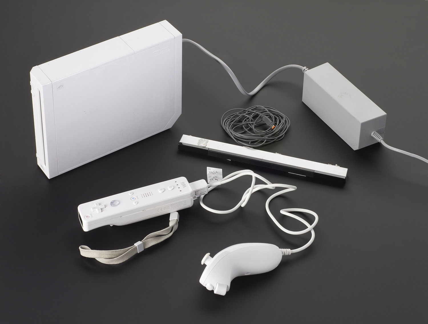 White games console and assorted controllers and peripherals