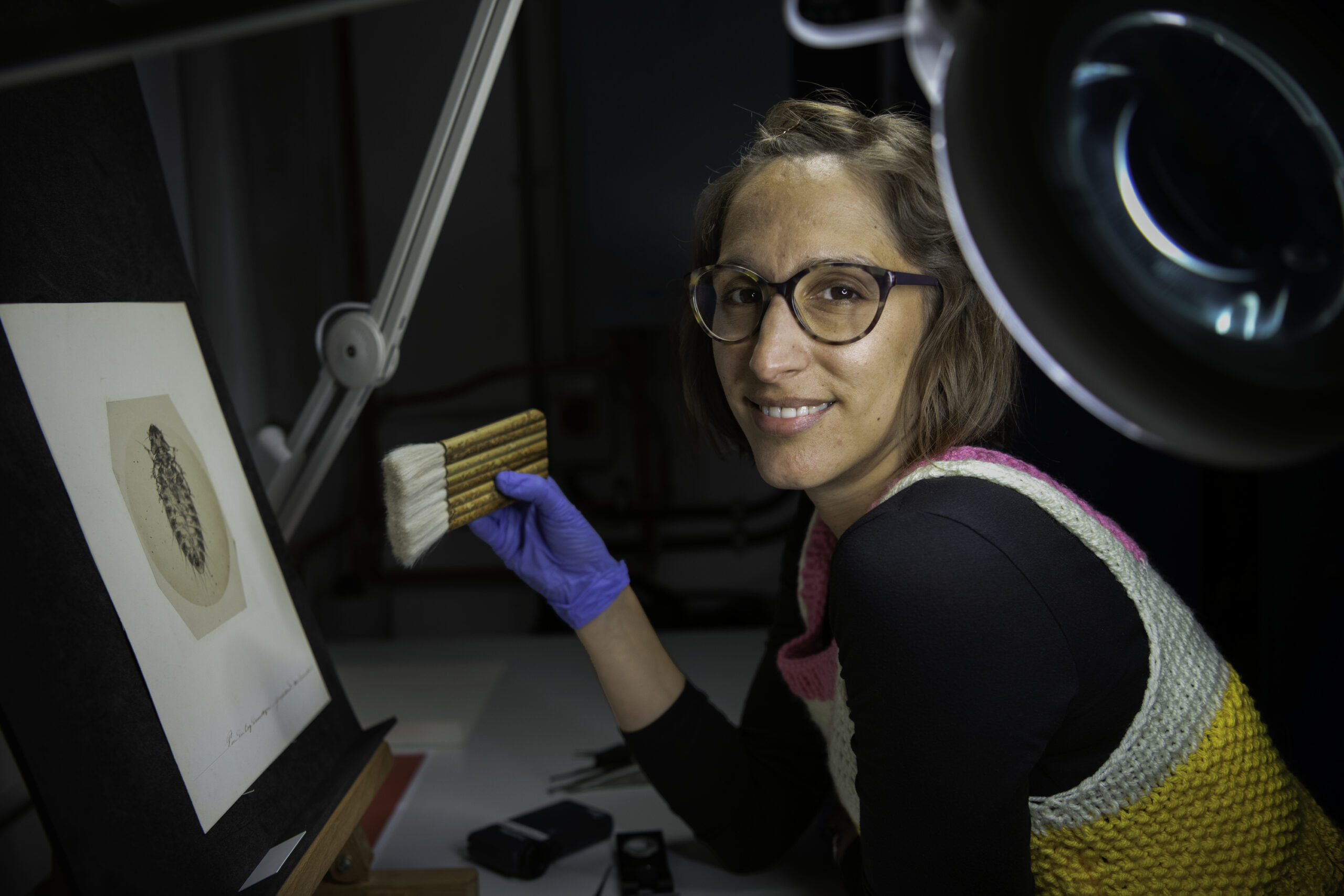 Vanessa using a brush to conserve a photograph