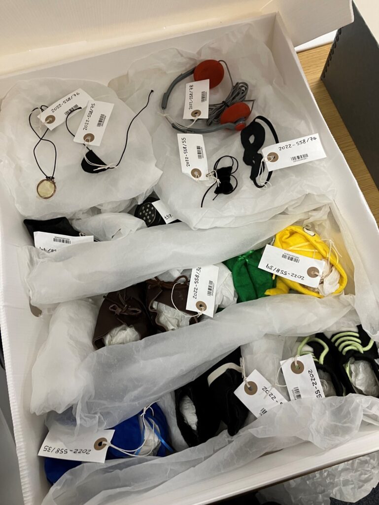 Archival box with Gordon the Gopher's outfits carefully packed inside