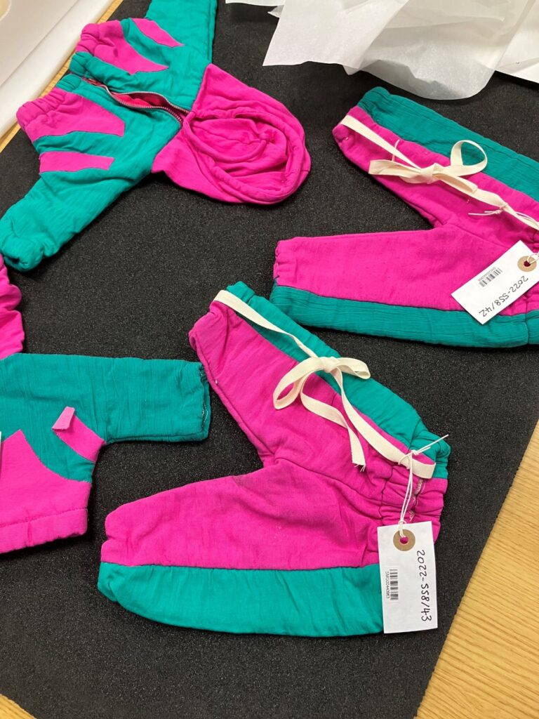 Bright pink and turquoise puppet-sized shellsuits