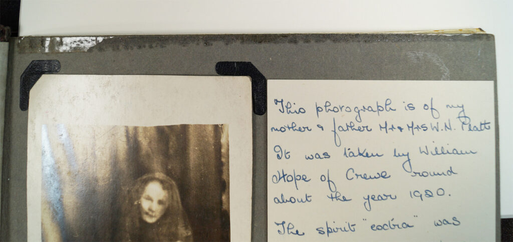 An old photo album with shiny sticky tape visible along the edge, but not touching the photo inside