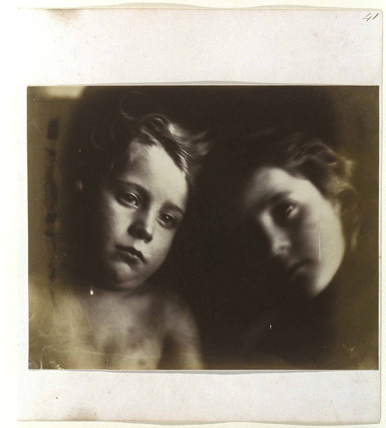 A slightly blurry photograph of two young children