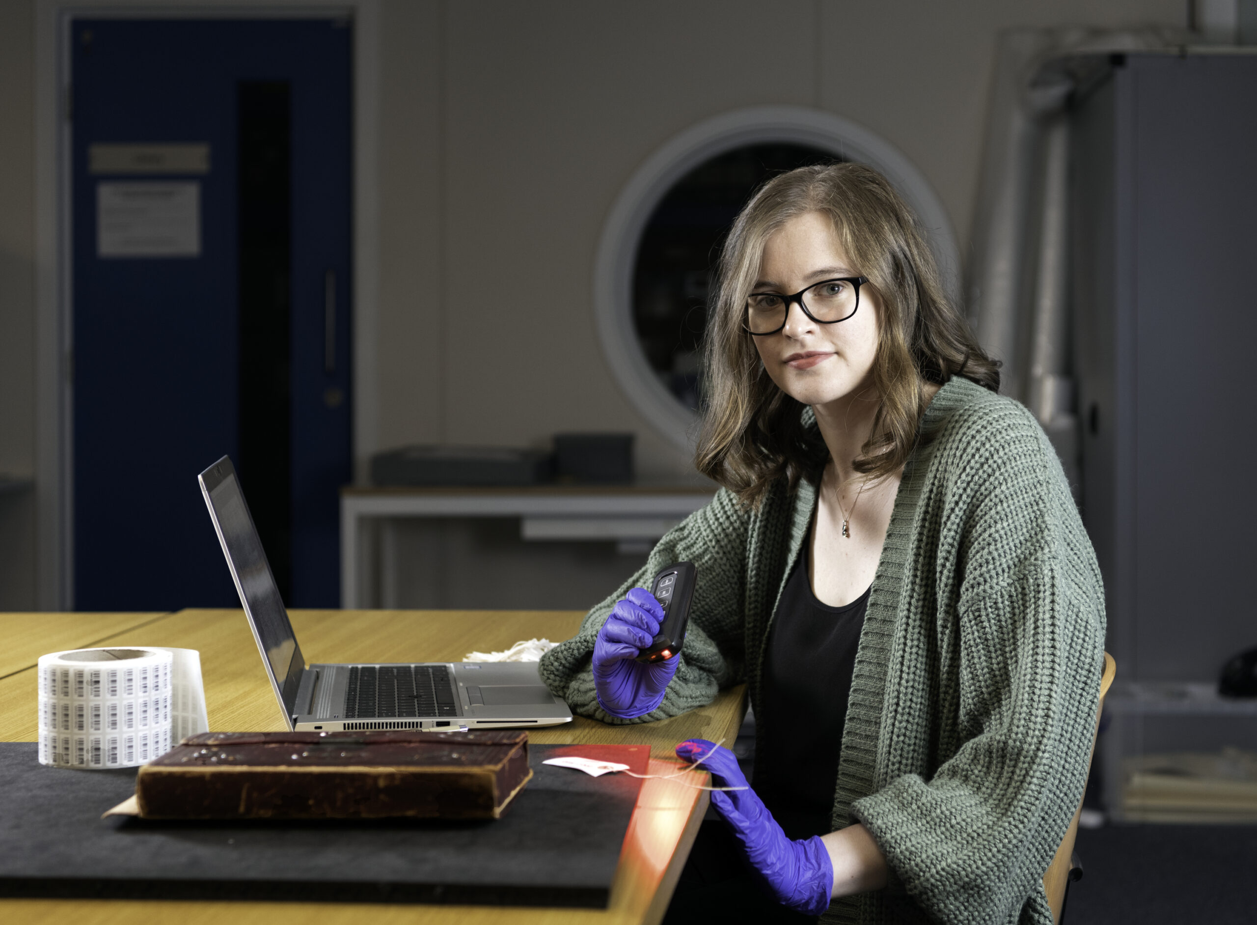 Alex points a barcode scanner at a collection object