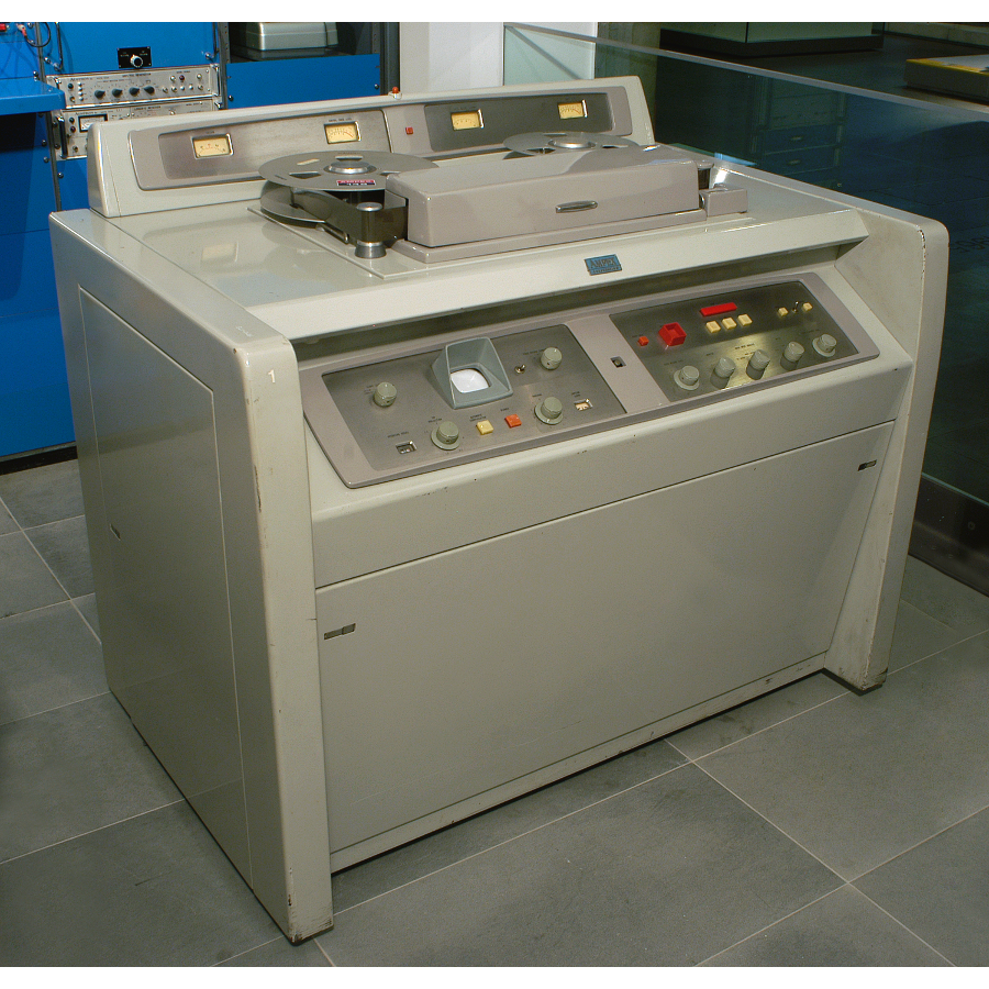 A large grey cabinet with tape reels and buttons