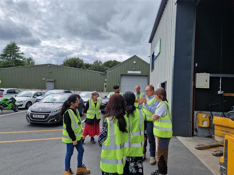 the youth forum members wearing high vis jackers outside the recycling plant
