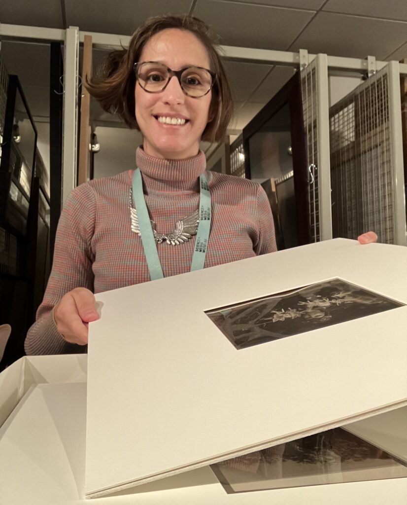 Vanessa holding one of the photographs.