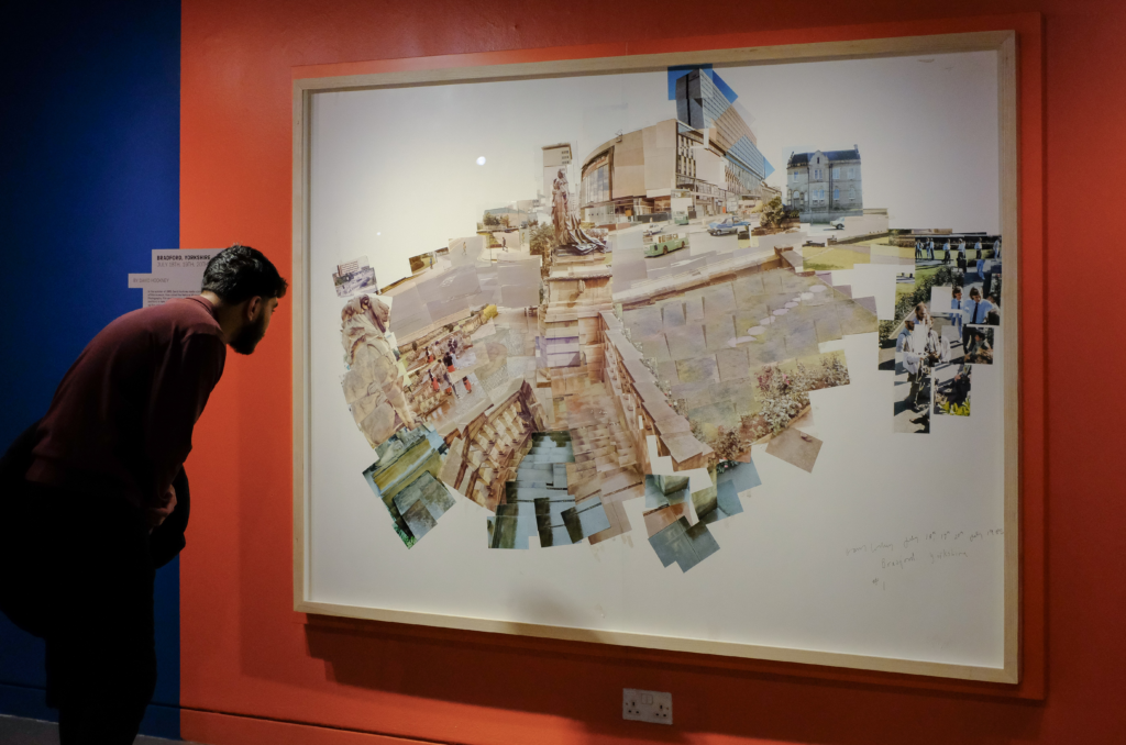 A visitor looking at one of Hockney's joiners in the gallery