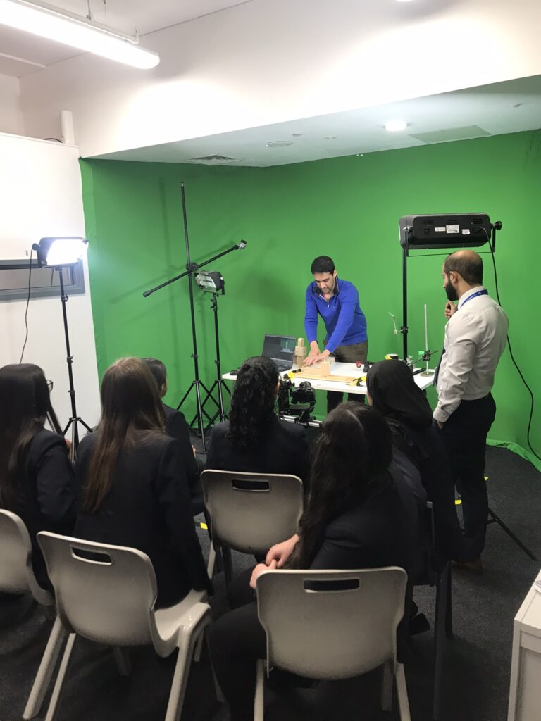 School students watching Arfaan demonstrating an animation technique