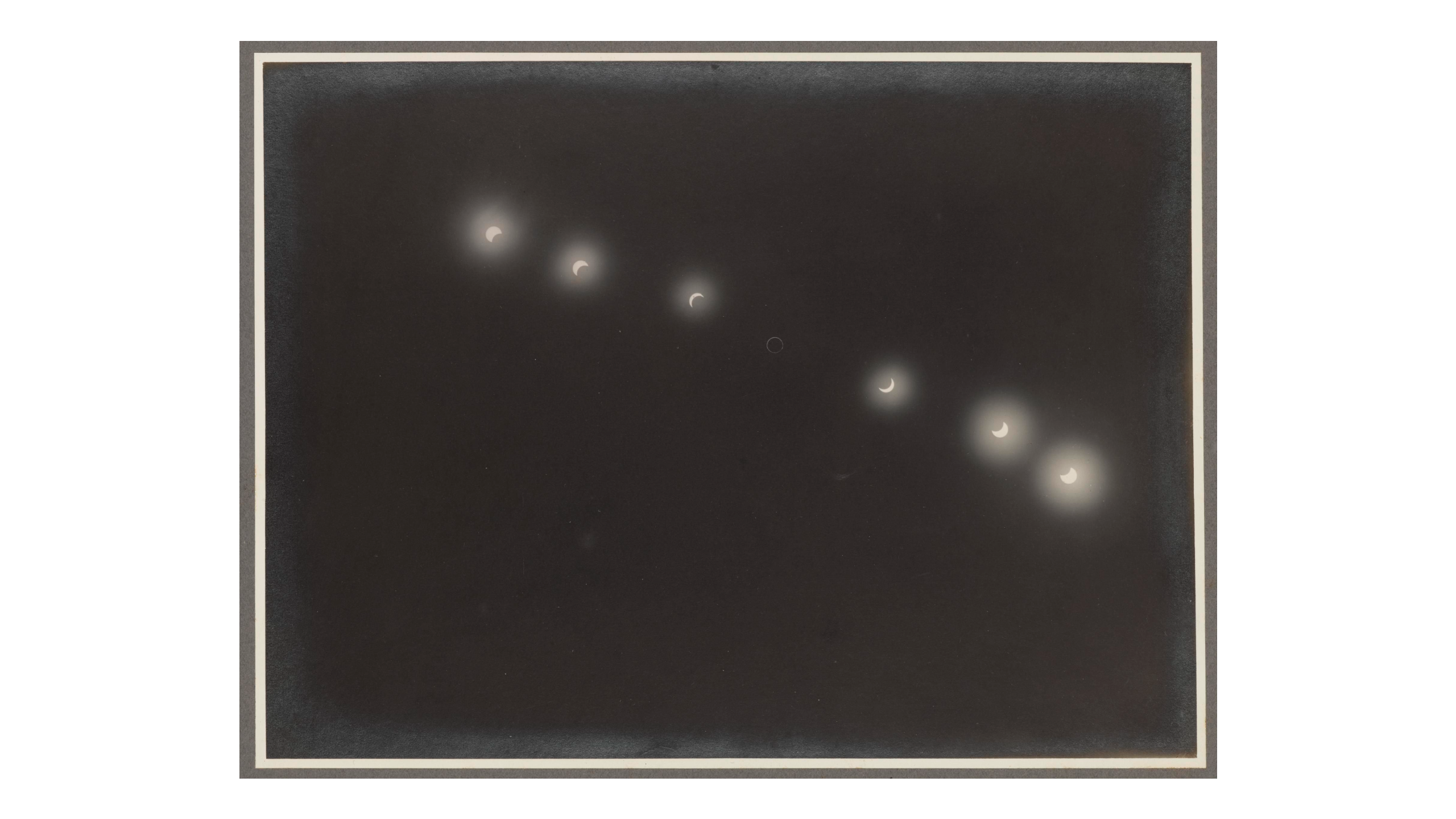 A series of small bright dots spanning bottom right to top left of a dark black sky.