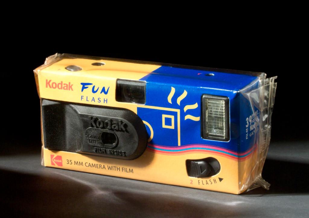 A disposable camera in blue and yellow packaging.