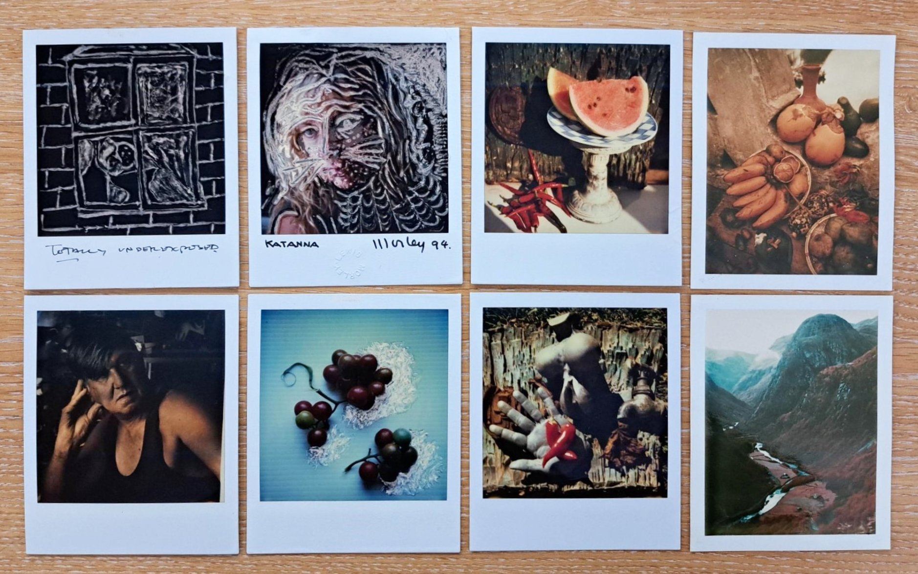 8 colourful polaroid photos on a wooden desktop