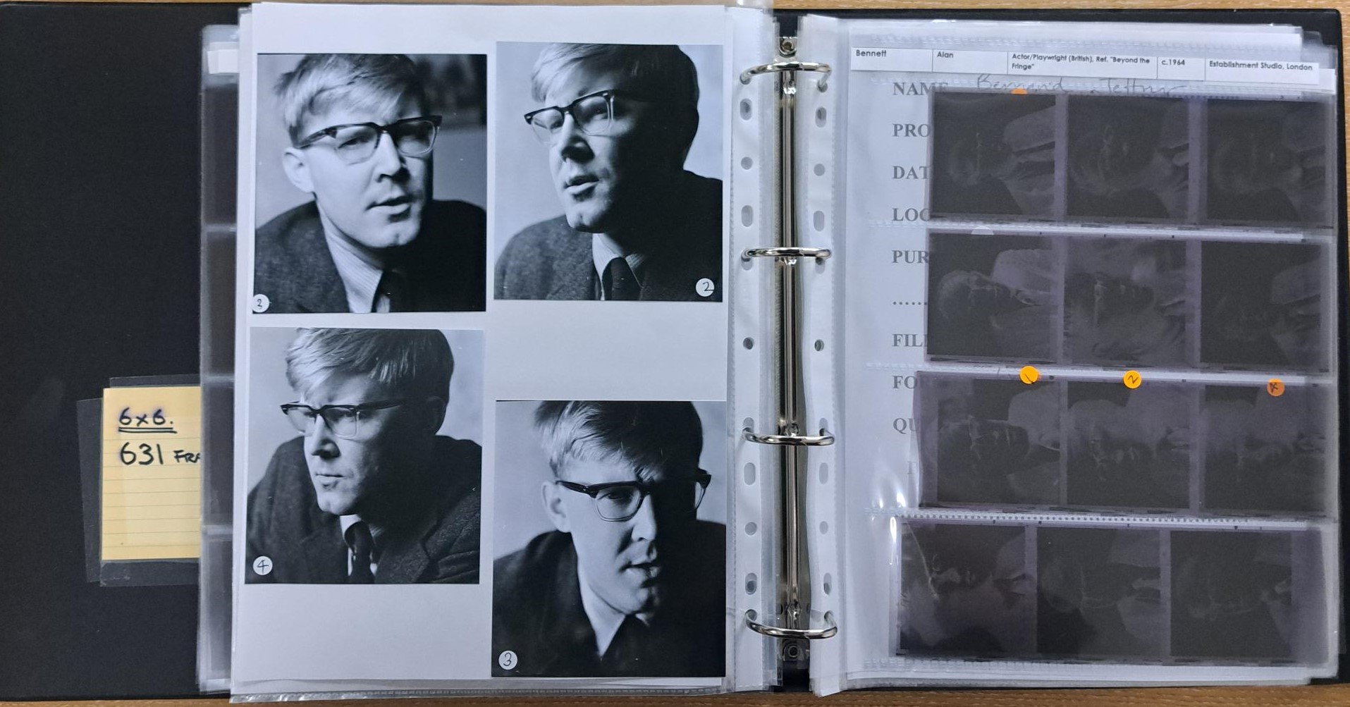 An ringbinder opened to a page of prints and negatives of the writer Alan Bennett