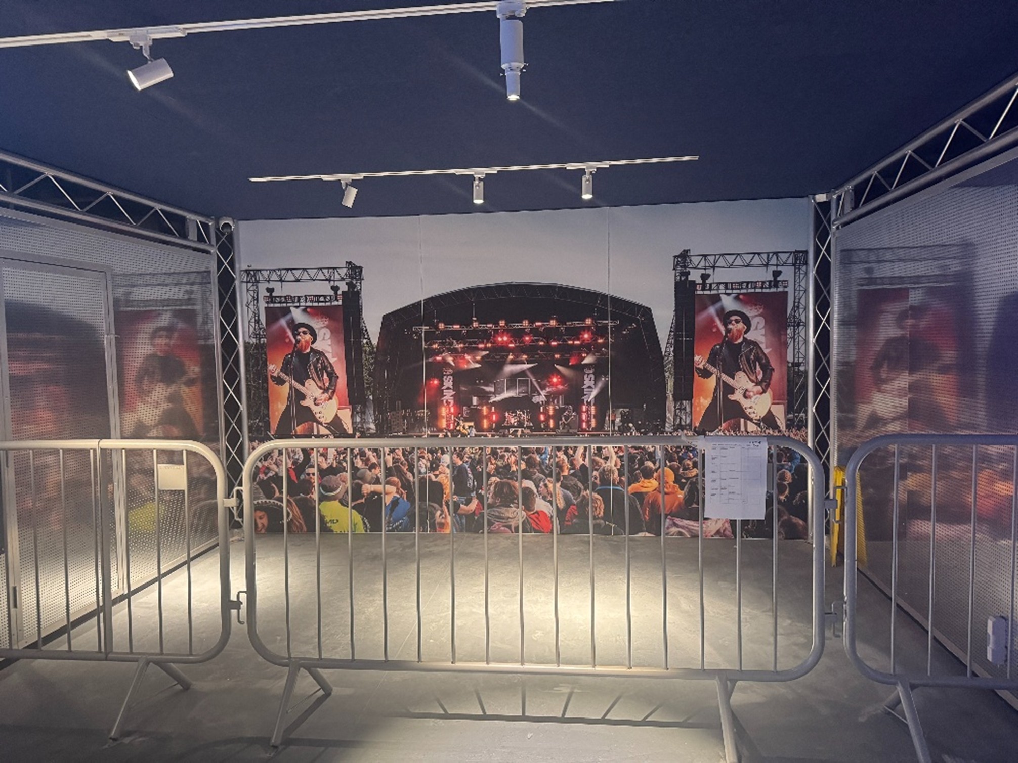 The gig zone with backdrop of a festival stage and crowd barriers, before objects were installed