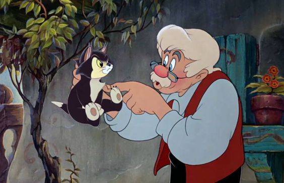 Animated cat Figaro held up by an old man in the film Pinocchio