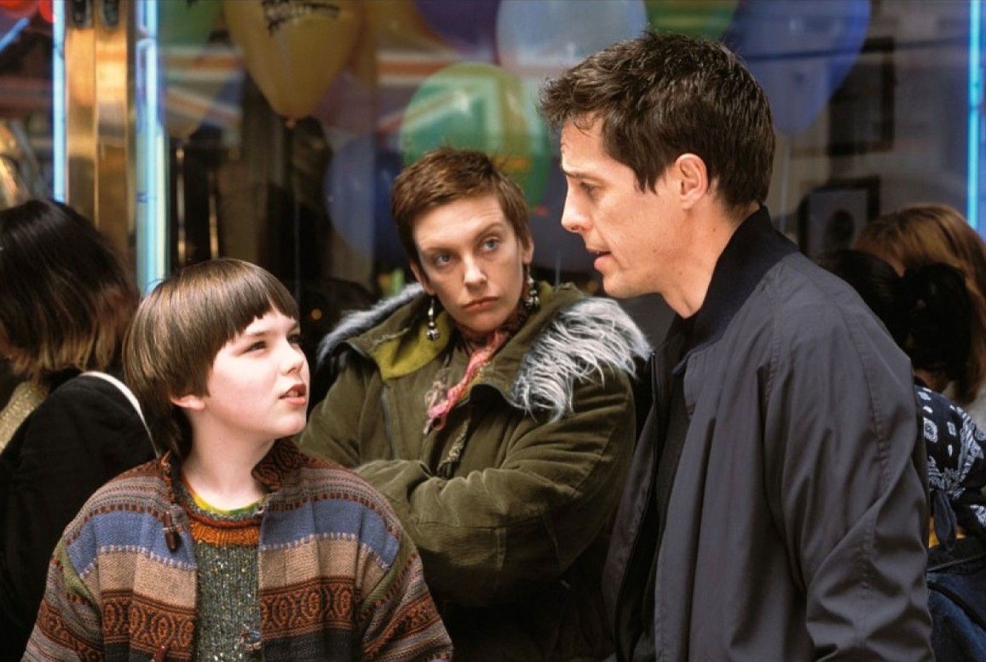 Nic Hoult talks to Hugh Grant as Toni Colette looks on