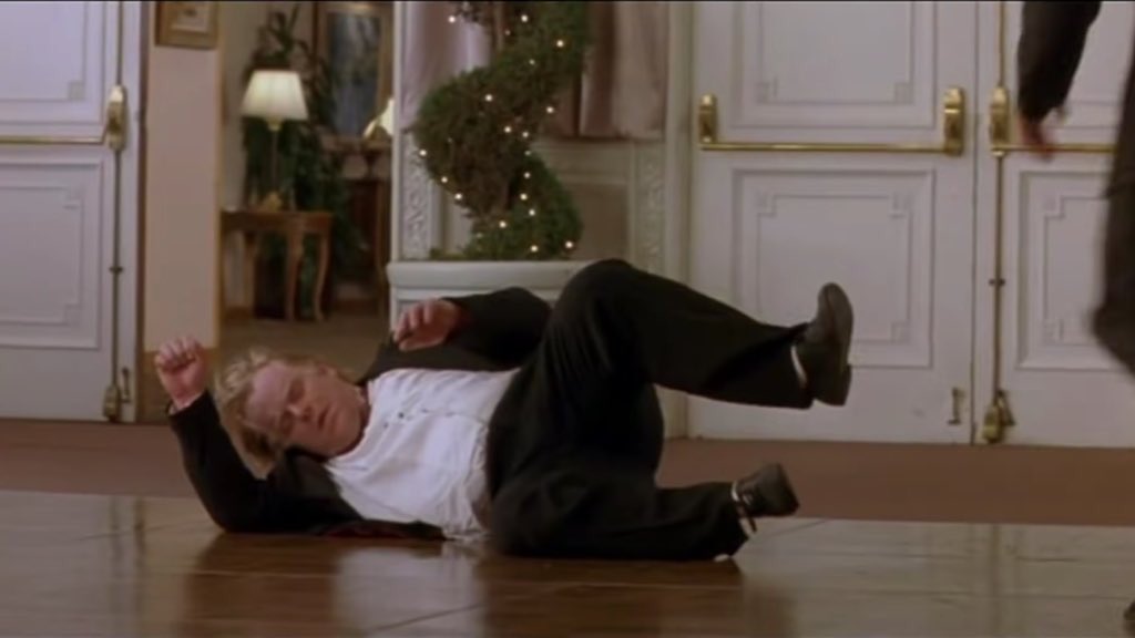 Phillip Seymour Hoffman falls to the floor of a ballroom.