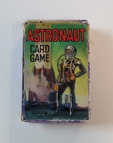 Astronaut card game box, with scuffed edges and clear tape across one side