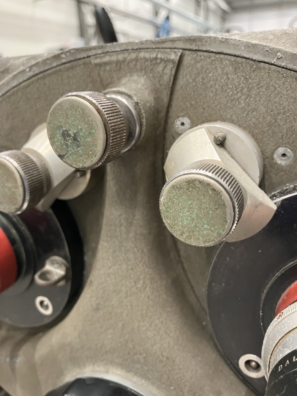 Close-up of the round metal knobs on the side of the camera, which are worn and corroded